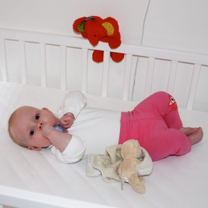 Tabitha looks tiny in her big cot!